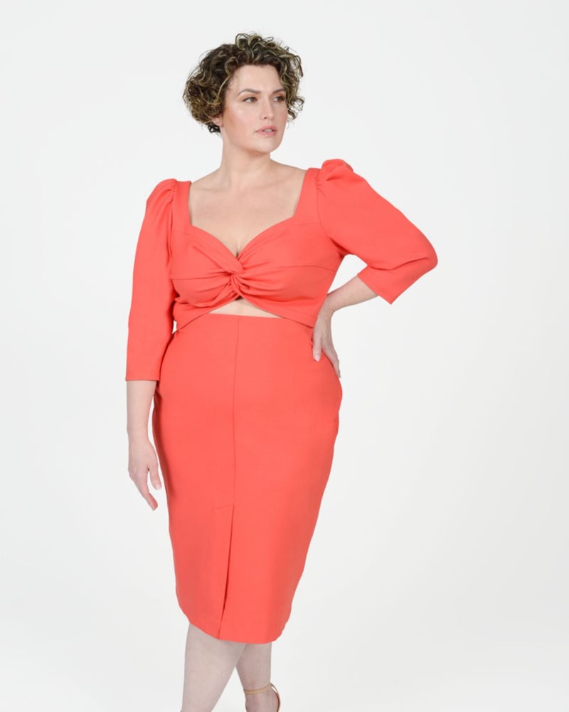 Front of a model wearing a size 16 Val Double Kick Skirt in Peach by MAYES NYC. | dia_product_style_image_id:283089